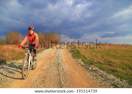 Bike on sunny road under gloomy sky