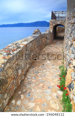 Narrow street and balcony inside old Byzantine town near the Mediterranean sea, Monemvasia, Greece