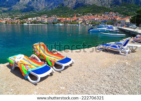 Sunny sea shore with beach chairs near the Adriatic sea coast, Makarska, Croatia