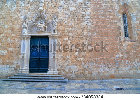 Decorated door and window with Venetian style on a church wall, old town of Dubrovnik, Croatia