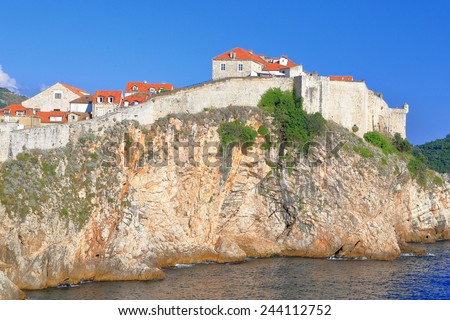Fortified walls of Dubrovnik old town above blue Adriatic sea, Croatia