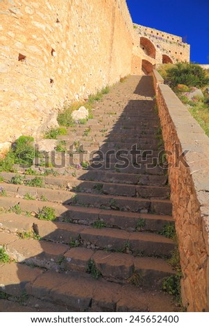 Long row of stairs climb along fortified walls to Venetian castle of Palamidi, Nafplio, Greece