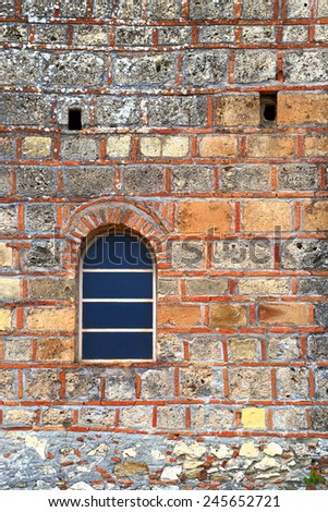 Detail of Byzantine brick wall and window of a church inside Mystras fortress, Greece