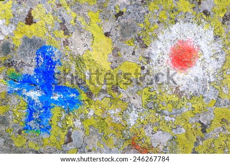 Faded pair of trail signs painted on rocks