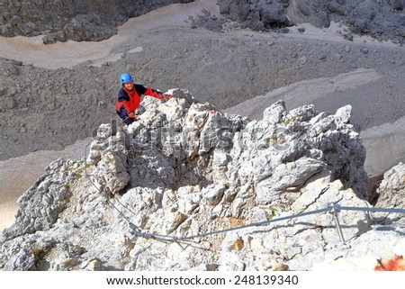 Aerial via ferrata route and remote climber above the void, \