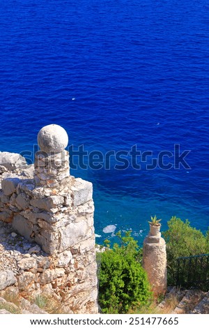 Stone ornaments on a fence above blue Adriatic sea, Trsteno, Croatia