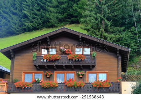 Wooden facade of a building decorated with flowers in South Tirol, Austria
