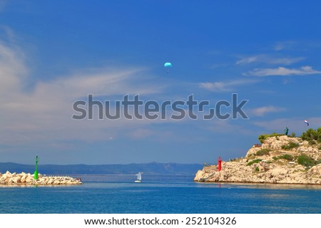 Para sailing above the blue water of the Adriatic near small resort on Dalmatian coast, Makarska, Croatia