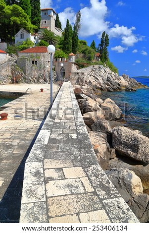 Grey stones on the pier protecting small harbor near the Adriatic sea, Trsteno, Croatia