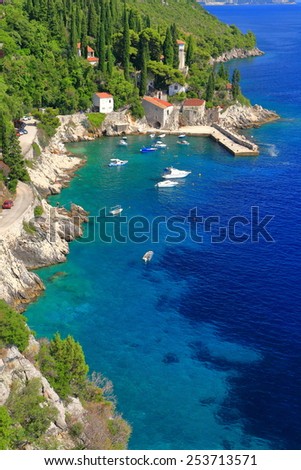 Small boats on shallow water inside traditional harbor near the Adriatic sea, Trsteno, Croatia