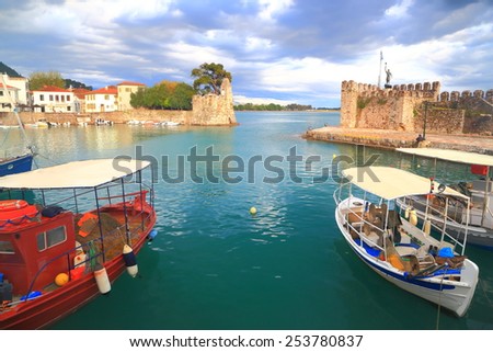 Calm waters inside Nefpaktos harbor and fishing boats protected against stormy weather, Greece
