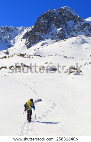 Mountaineer follows a snow covered plateau in winter
