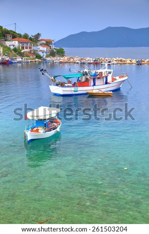 Traditional fishing boats on shallow water inside Agia Kiriaki harbor, Greece