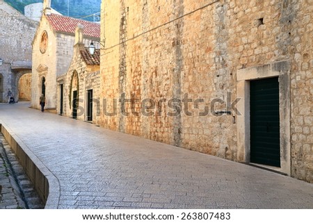 Dark street sided by stone walls of medieval buildings, Dubrovnik, Croatia