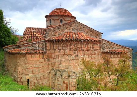 Byzantine architecture of an old church under dark clouds, Mystras, Greece