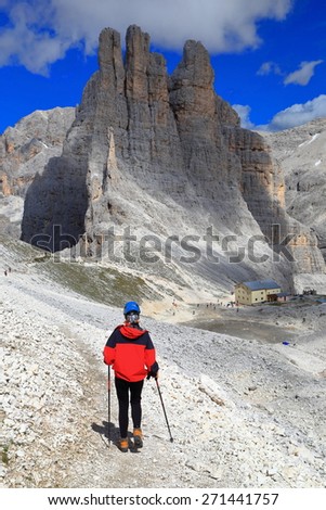 Climber woman descending to impressive Vajolet towers, Catinaccio massif, Dolomite Alps, Italy