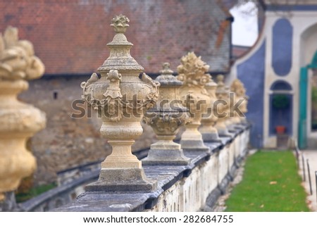Detail of medieval castle garden with stone carvings on a fence, Cesky Krumlov, Czech Republic