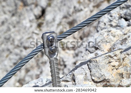 Iron peg and steel cable along via ferrata route, Dolomite alps, Italy