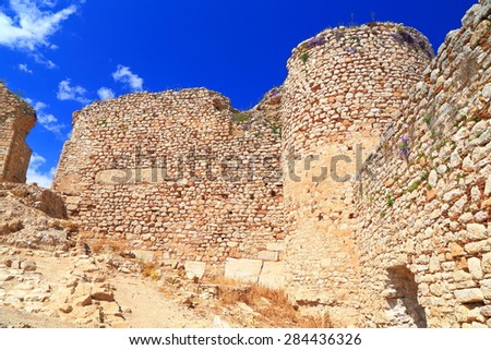 Ruined walls of a medieval fortress in sunny day, Argos, Greece