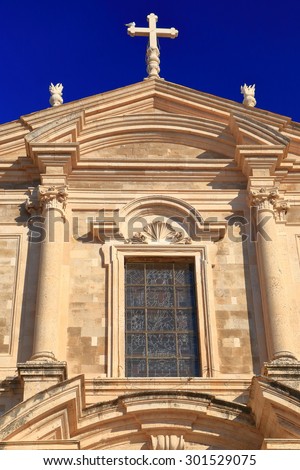Building of Baroque church with stone decorated facade inside Dubrovnik old town, Croatia