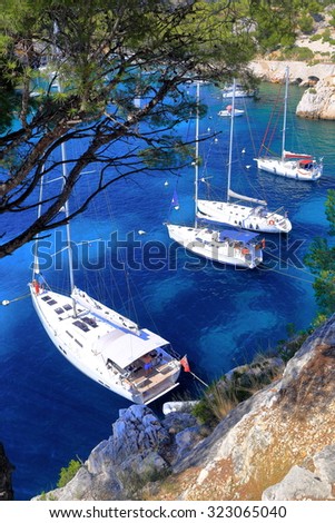 Overview to blue water inside a calanque and sail boats near Cassis, France