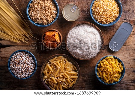 An assortment of pantry ingredients on a rustic wood table top. 商業照片 © 