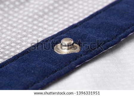 Press-stud (fastener) on blue shirt plank closeup. ストックフォト © 