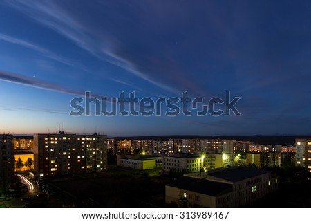 dark blue sky with clouds and stars at night city