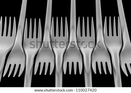 Photo of plastic forks on a black background