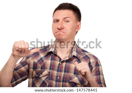 Man in a plaid shirt showing thumbs up to himself