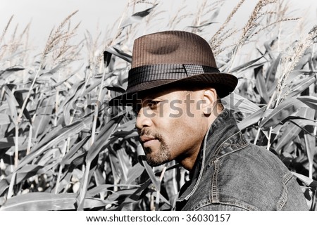 male profile against a cornfield