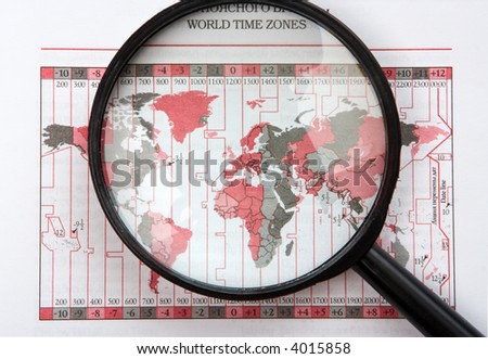 black magnifier on world map with time zones