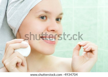 young beauty woman clean teeth thread in bath room