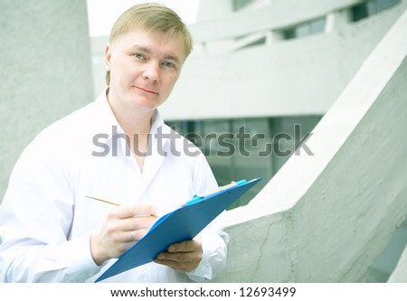 Cheerful young businessman on stairs