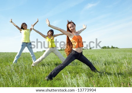 three girlfriend in green field under blue sky