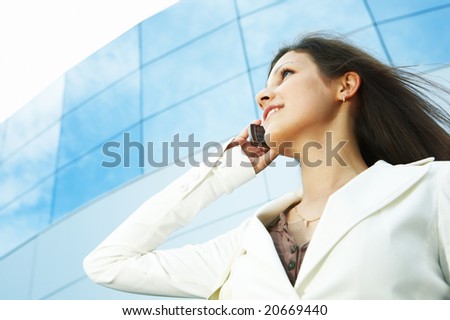 beautiful business woman on the phone at modern building