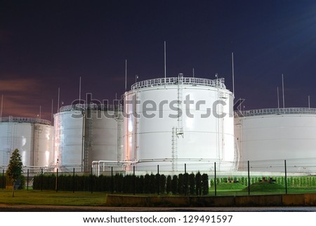 Fuel storage tanks at oil terminal by night