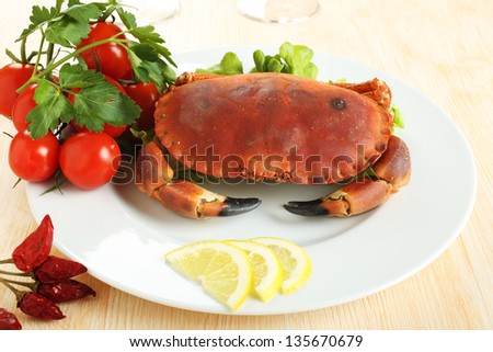 boiled crab with tomatoes and parsley on the ceramic dish