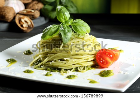 pasta spaghetti with pesto  genovese green background