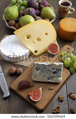 top view Various types of cheese and fruit on rustic wooden table