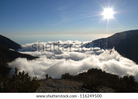 Morning sun, beautiful fluffy clouds and forest at mount Olympus