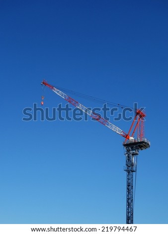 Industrial construction crane in the blue sky background