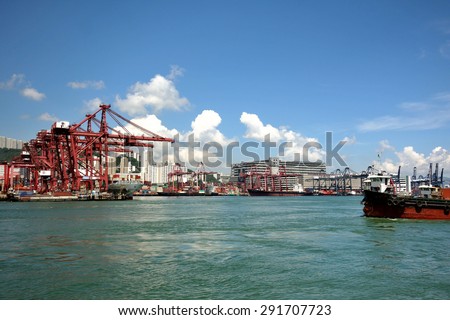 HONG KONG -June 16,2015 : Gantry crane and containers at Hong Kong commercial port. Port of Hong Kong is one of the busiest ports in the world.