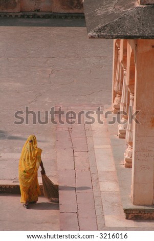 Woman in sari sweeping, India