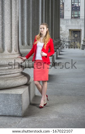 Dressing in a red blazer, white under wear, a red skirt and open toes high heels, a young blonde student is standing outside an office building. / Portrait of Young Student