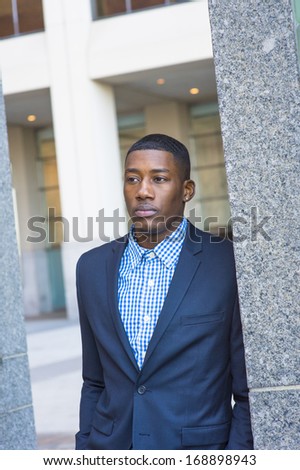 A young handsome black guy is confidently looking forward. / Portrait of Young Handsome Black Guy