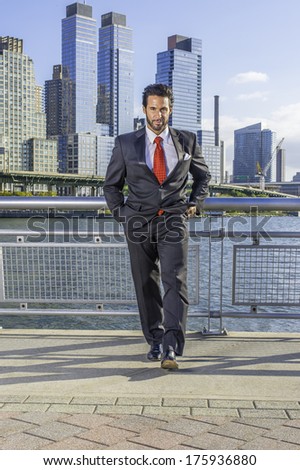 Dressing is a black suit and red tie, a handsome, sexy, middle age businessman with mustache and beard is confidently walking in a busy business district. / Portrait of Businessman