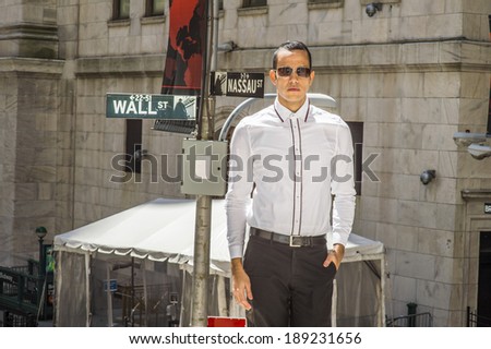 Businessman on Wall Street. Dressing in a white shirt, black pants, wearing sunglasses, one hand putting in a pocket, a young handsome man is standing on street, confidently looking forward.