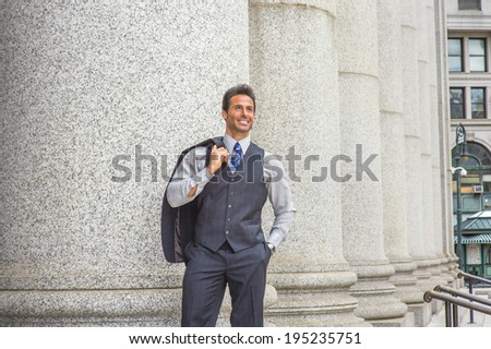 Man Waiting Outside. Dressing in light gray shirt, dark blue vest, necktie, jacket taken off on shoulder, a  handsome, middle age businessman is standing by columns outside,  smiling, looking up.