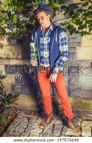 Man missing you. Dressing in blue, white pattern shirt, blue hoodie vest,  red jeans, brown leather boot shoes, wearing woolen Fedora hat, a young guy is holding a white rose, looking down, thinking